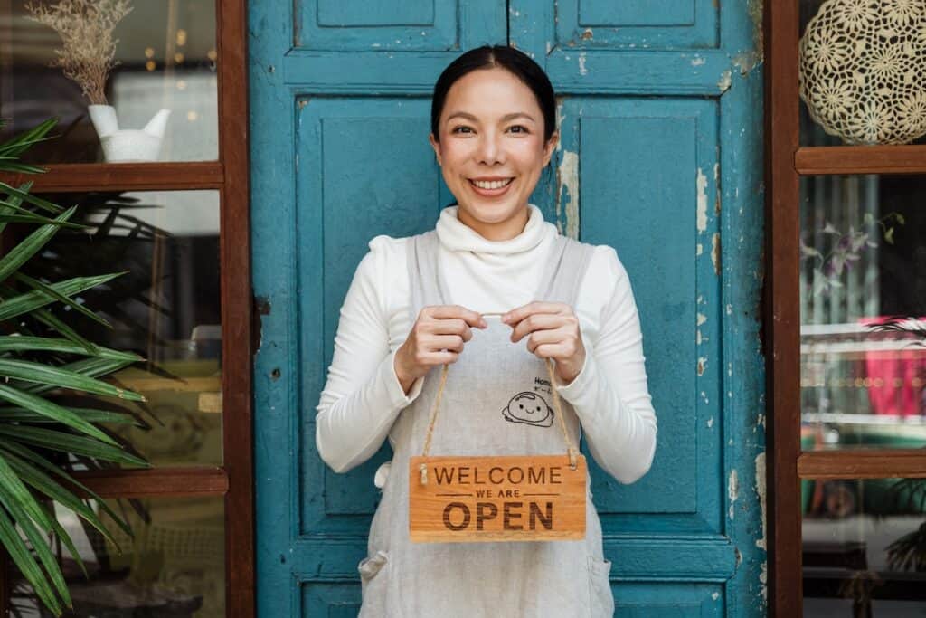 woman with sign in front of door