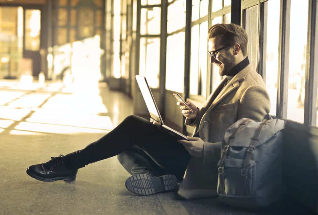 man sitting looking at computer