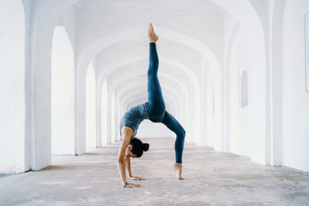 woman doing back bend leg up in air