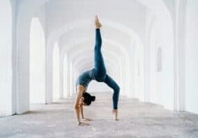 woman doing back bend leg up in air